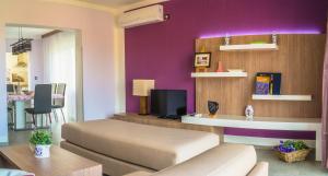 a living room with a couch and a tv at Anikol Apartments in Selce