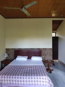 Ένα ή περισσότερα κρεβάτια σε δωμάτιο στο Rijasa Homestay +26 φωτογραφίες
