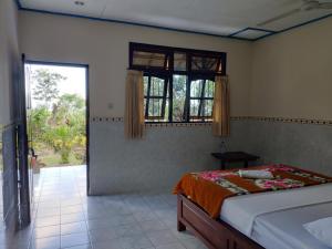 Ένα ή περισσότερα κρεβάτια σε δωμάτιο στο Rijasa Homestay