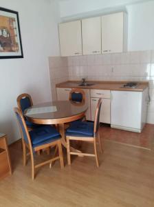 トゥチェピにあるApartmani JANADORAの部屋にテーブルと椅子のあるキッチン