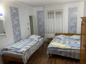 En eller flere senger på et rom på Pensiunea Robi&Norbi Sovata