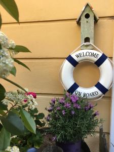 a life preserver is hanging on a wall with flowers at Villa Art'è in Locarno