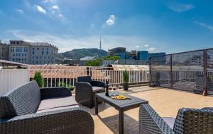 a patio with chairs and a table on a balcony at Hotel Imperial House in Tbilisi City