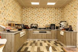 a kitchen with wooden cabinets and a patterned wall at Parque Florida in Ciudad-Rodrigo