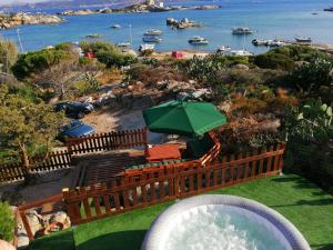 a green and white pool with a boat on top of it at B&B Il Corallo in La Maddalena