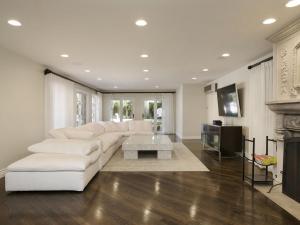 a living room with a white couch and a fireplace at Villa Teresita - Beautifully gated Mediterranean estate in Los Angeles