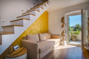 a living room with a couch and stairs at Casa Rustica in Mali Lošinj