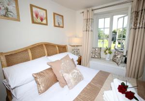 a bedroom with a white bed with pillows and a window at No 2 in Kirkby Lonsdale