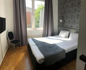 Postel nebo postele na pokoji v ubytování Viktoria Hotell & Konferens