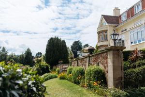 an old house with a garden in front of it at Northfield Hotel in Minehead