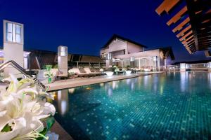 a swimming pool in front of a house at Angsana Hangzhou in Hangzhou