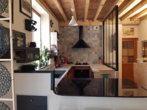 a kitchen with a large island in the middle at J'irais dormir à Lyon in Lyon