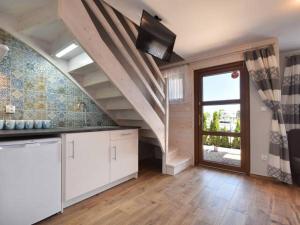 a large kitchen with a staircase and a window at WCZASOWISKO TOLKOWO in Jarosławiec