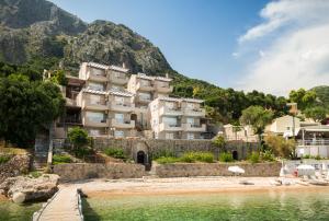 a building on the shore of a body of water at Glyfa Beach Villas in Barbati