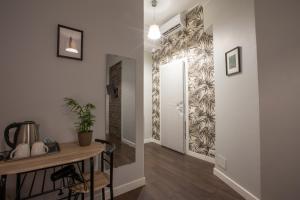 a hallway with a console table and a wall mural at maribea rome center in Rome