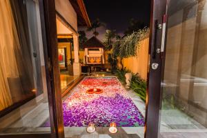 a room with a pool in the middle of a house at Aldeoz Grand Kancana Villas Resort Bali in Kerobokan