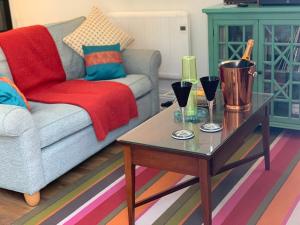 a living room with a couch and a coffee table at Artists Cottages Artists Loft near Hornbeam Park Free Parking in Harrogate