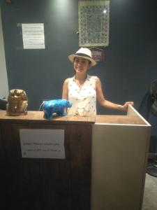 a woman in a hat standing behind a counter at H100 Pyramids View in Giza