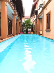 a swimming pool in the middle of a building at Jasmine Luangprabang Hotel in Luang Prabang