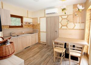 a kitchen with a table and chairs in a room at Honey Paradise glamping resort in Dobova