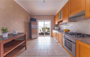 a kitchen with wooden cabinets and a stove top oven at Windmill Modern with Pool in Lagos