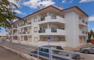 a white building with a car parked in front of it at Windmill Modern with Pool in Lagos
