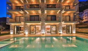 a hotel with a swimming pool in front of a building at Carruba Boutique Hotel in Kas