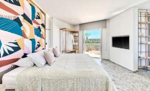 a bedroom with a large bed with a painting on the wall at Arkadia Hotel in Kipseli