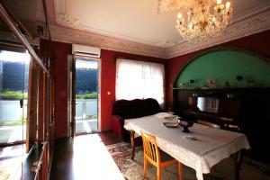 a dining room with a table and a chandelier at Nature House in Kutaisi