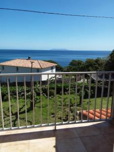 a balcony with a view of the ocean at Chambre d hôtes chez raymonde et sandrine in Luri