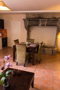 a dining room with a table and a fireplace at Terra Gasconha in Barbaste