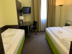 Voodi või voodid majutusasutuse Behringers City Hotel Nürnberg toas
