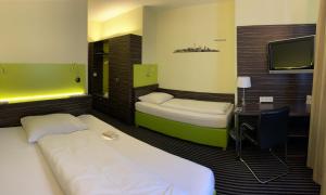 Voodi või voodid majutusasutuse Behringers City Hotel Nürnberg toas
