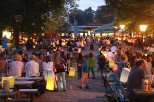 a crowd of people sitting at tables in a park at Pure Nature Munich - Amper Meadows/Freising in Haag an der Amper