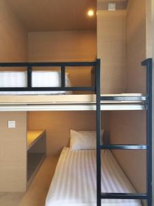 a bunk bed room with two bunk beds in it at XOXO Kuta Legian Hostel in Legian