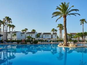 duży basen z palmami i budynkami w obiekcie BQ Alcudia Sun Village w Playa de Muro