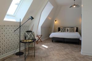 En eller flere senge i et værelse på Logis Hotel Le Relais du Teulet