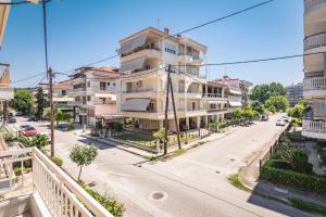 an apartment building on a street in a city at Tom's House in Tríkala