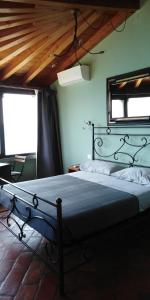 a bedroom with a bed in a room with two windows at B&B La Forcella in Sarnico