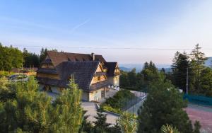 a large house with a gambrel roof at Kocierz Resort - Villa in Andrychów