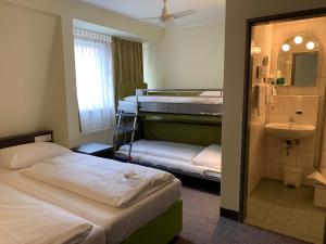 Voodi või voodid majutusasutuse Behringers City Hotel Nürnberg toas