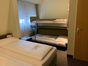 Voodi või voodid majutusasutuse Behringers City Hotel Nürnberg toas