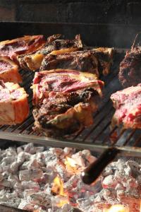 a grill with a bunch of meat and bread at Agroturismo Sidreria Txindurri Iturri in Deba