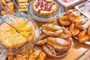 a table with different types of pastries and pies at Guerrini Hotel in Castiglioncello