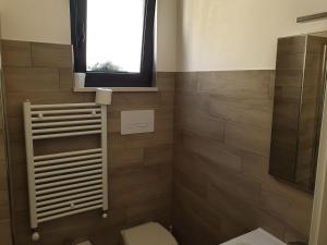 a bathroom with a toilet and a window at Nonna Livia by La Puglia in un trullo in Alberobello