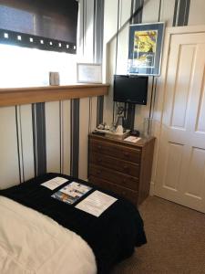 a bedroom with a bed and a television at Drumdale Bed and Breakfast in Inverness