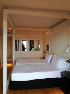 a bedroom with a large bed with white pillows at Hotel Trias in Palamós