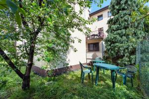 a table and chairs in the yard of a building at Dom Kolping in Krakow