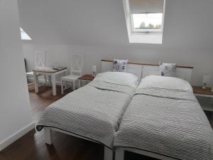 two beds sitting next to each other in a room at U Marka in Dąbrowy