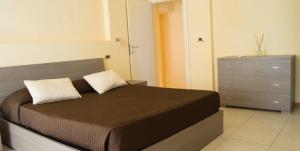 a bedroom with a bed with a dresser and a drawer at Guerrini Hotel in Castiglioncello